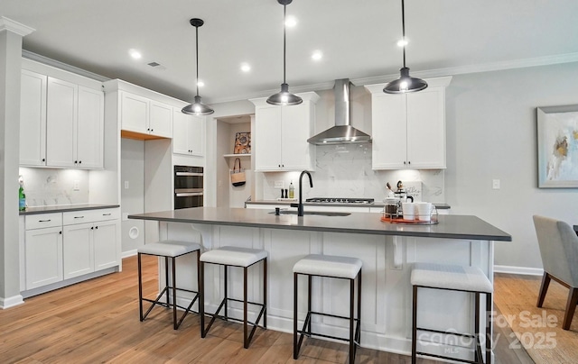 9843 Quercus Ln, Huntersville, NC 28078 - kitchen with wall chimney range hood, backsplash, white cabinets, double oven, and recessed lighting
