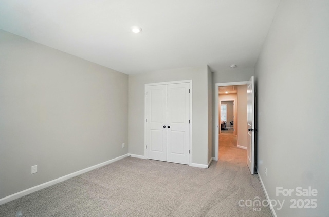 9843 Quercus Ln, Huntersville, NC 28078 - unfurnished bedroom featuring a closet, light carpet, and recessed lighting