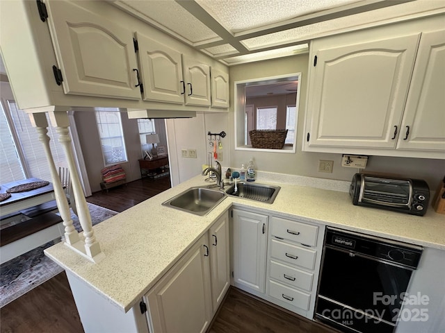 104 Pine St Unit 201, New London, NC 28127 - kitchen with black dishwasher, a peninsula, healthy amount of natural light, and dark wood-style floors