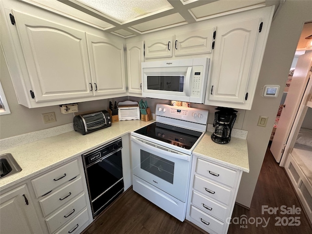 104 Pine St Unit 201, New London, NC 28127 - kitchen featuring white appliances, dark wood-style floors, white cabinetry, and light stone counters