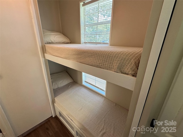 104 Pine St Unit 201, New London, NC 28127 - unfurnished bedroom with multiple windows and dark wood-style floors