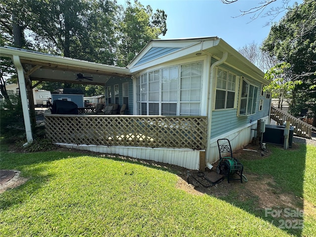 104 Pine St Unit 201, New London, NC 28127 - view of property exterior featuring a lawn and a ceiling fan