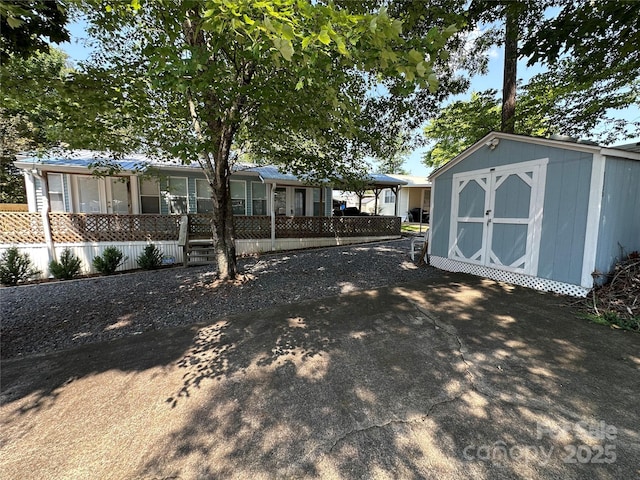 104 Pine St Unit 201, New London, NC 28127 - view of front of property featuring a storage shed and covered porch