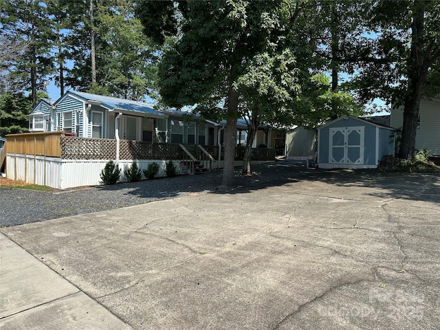 104 Pine St Unit 201, New London, NC 28127 - view of front facade with a storage unit and a metal roof