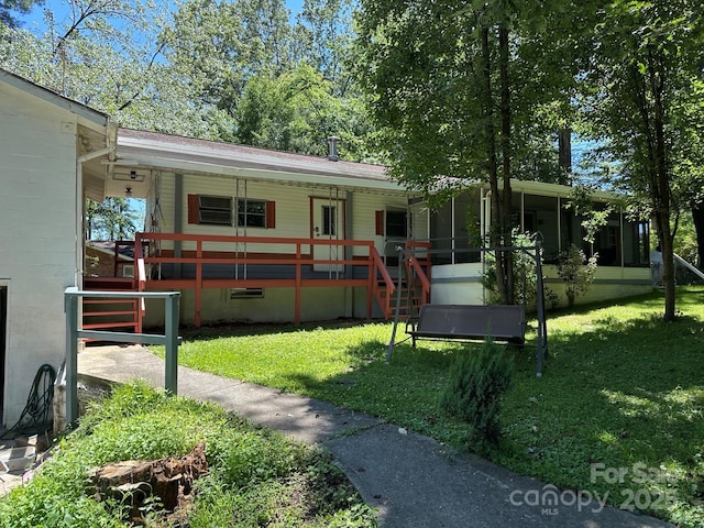 3036 Holly Hill Rd, Hendersonville, NC 28792 - view of front facade featuring covered porch, stairway, a front lawn, and concrete block siding