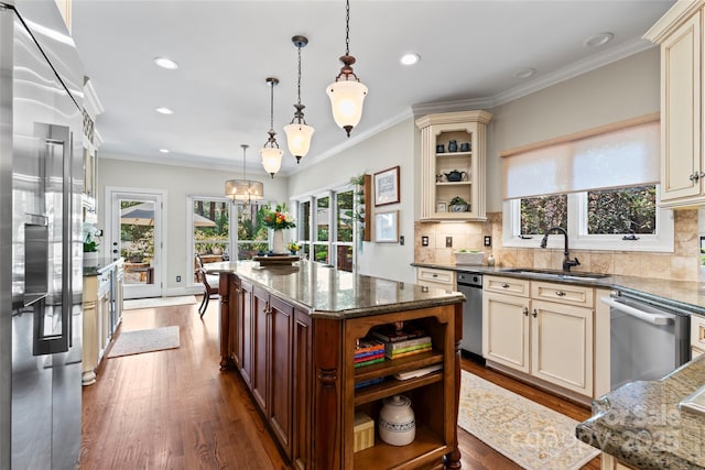 19245 Stableford Ln, Cornelius, NC 28031 - kitchen featuring stainless steel appliances, cream cabinets, healthy amount of natural light, recessed lighting, and ornamental molding