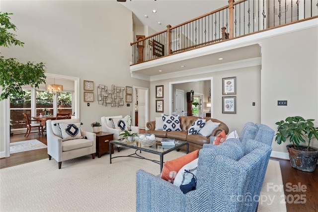 19245 Stableford Ln, Cornelius, NC 28031 - living area featuring a towering ceiling, wood finished floors, a chandelier, recessed lighting, and crown molding