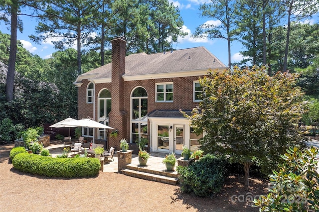 19245 Stableford Ln, Cornelius, NC 28031 - rear view of property with a patio area, a chimney, a shingled roof, french doors, and brick siding