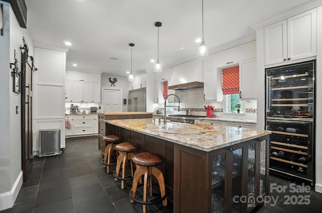 5005 Craftsman Ridge Dr, Matthews, NC 28104 - kitchen with beverage cooler, built in refrigerator, custom exhaust hood, backsplash, and recessed lighting