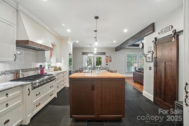 5005 Craftsman Ridge Dr, Matthews, NC 28104 - kitchen with wood counters, stainless steel gas stovetop, a center island, recessed lighting, and white cabinets