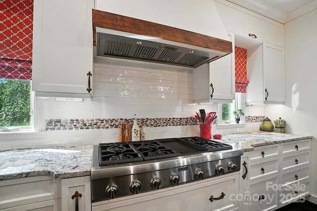 5005 Craftsman Ridge Dr, Matthews, NC 28104 - kitchen featuring premium range hood, stainless steel gas cooktop, backsplash, white cabinets, and light stone countertops