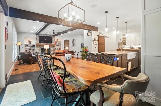 5005 Craftsman Ridge Dr, Matthews, NC 28104 - dining space with recessed lighting, a fireplace, beam ceiling, a ceiling fan, and arched walkways