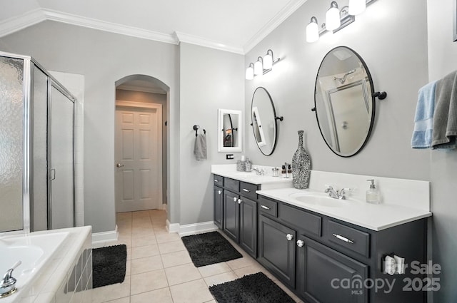 5005 Craftsman Ridge Dr, Matthews, NC 28104 - bathroom featuring double vanity, tile patterned flooring, a shower stall, crown molding, and a garden tub