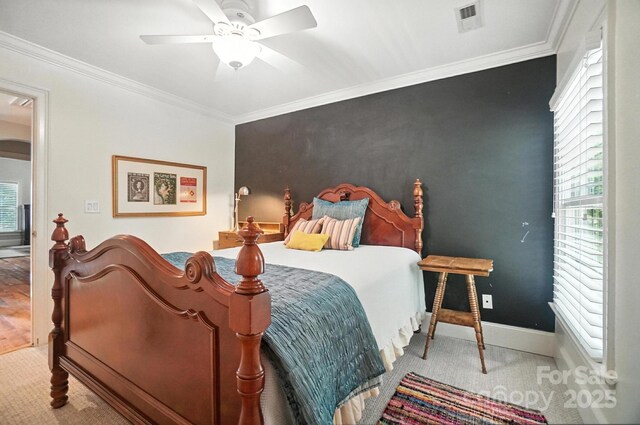 5005 Craftsman Ridge Dr, Matthews, NC 28104 - bedroom featuring multiple windows, an accent wall, crown molding, and a ceiling fan