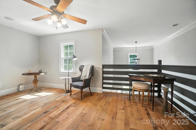5005 Craftsman Ridge Dr, Matthews, NC 28104 - living area featuring light wood finished floors, a ceiling fan, ornamental molding, and an upstairs landing