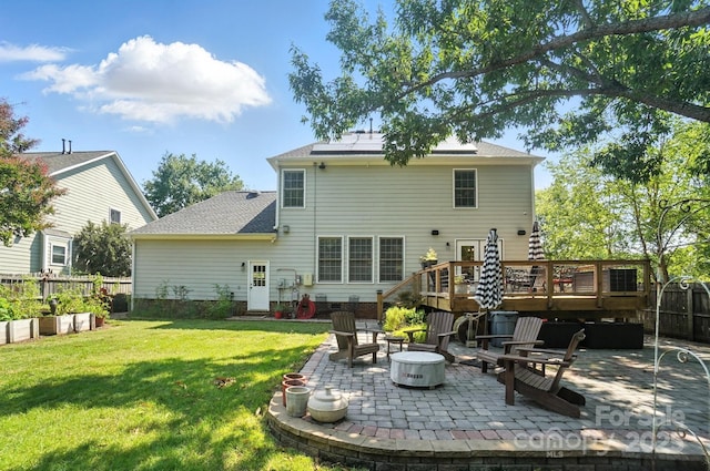5005 Craftsman Ridge Dr, Matthews, NC 28104 - rear view of house with a patio area, an outdoor fire pit, a wooden deck, roof mounted solar panels, and a shingled roof
