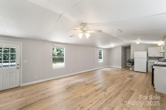1354 Springwood Ln, Rock Hill, SC 29730 - unfurnished living room with ceiling fan, light wood-style floors, healthy amount of natural light, and lofted ceiling