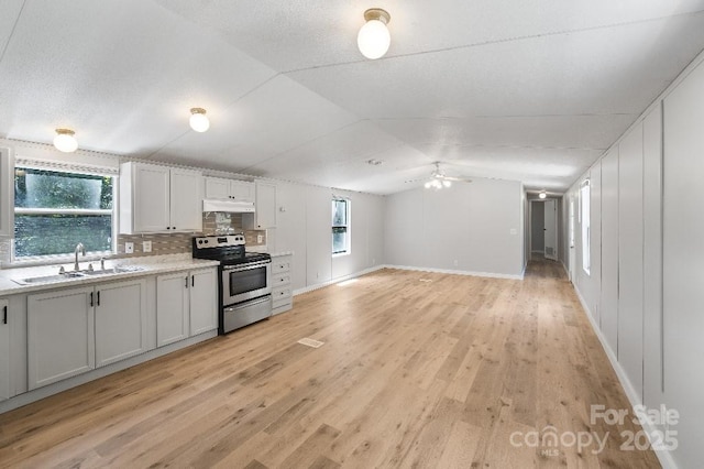 1354 Springwood Ln, Rock Hill, SC 29730 - kitchen with electric range, vaulted ceiling, under cabinet range hood, light countertops, and light wood finished floors