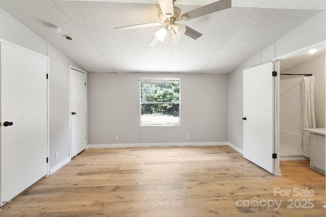 1354 Springwood Ln, Rock Hill, SC 29730 - unfurnished bedroom with vaulted ceiling, light wood-type flooring, a textured ceiling, and ceiling fan