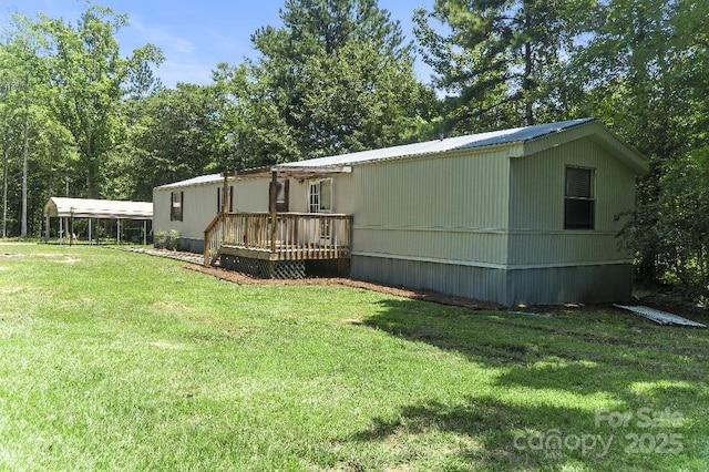 1354 Springwood Ln, Rock Hill, SC 29730 - rear view of house featuring a deck, a yard, and a metal roof