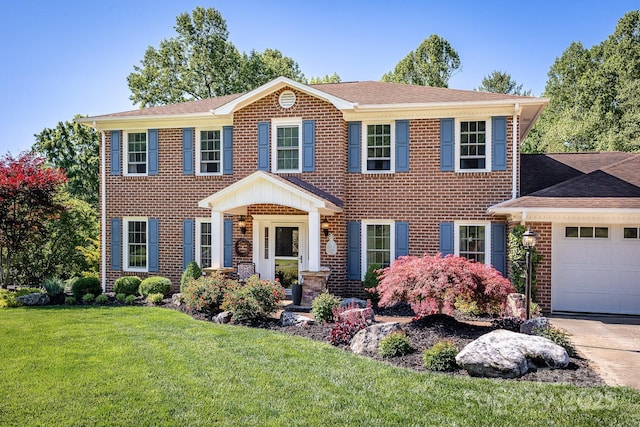 302 Redwood Pl, Lenoir, NC 28645 - view of front of house featuring a front lawn, an attached garage, brick siding, and a shingled roof