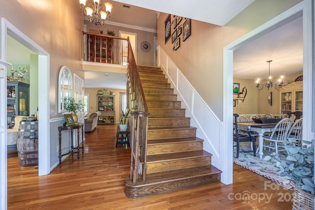 302 Redwood Pl, Lenoir, NC 28645 - stairs with a chandelier, wood finished floors, a towering ceiling, and ornamental molding