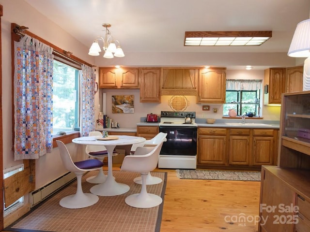 1090 Woolyshot Branch Rd, Hot Springs, NC 28743 - kitchen featuring white electric range oven, a baseboard heating unit, light wood-style floors, light countertops, and a chandelier