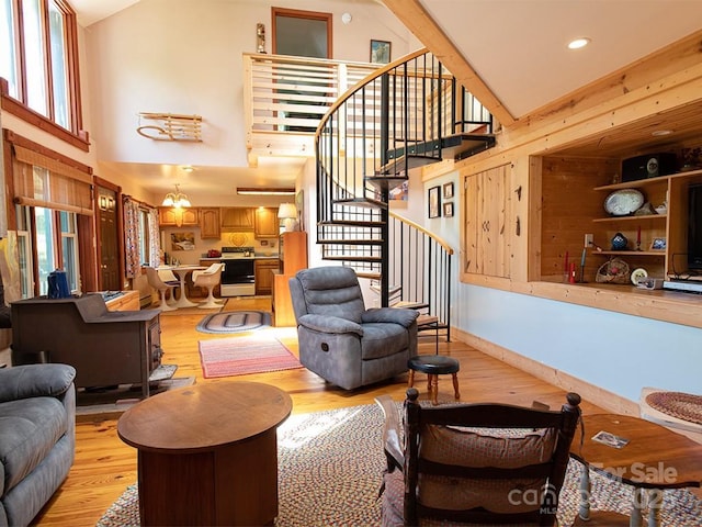 1090 Woolyshot Branch Rd, Hot Springs, NC 28743 - living room featuring light wood-style floors, high vaulted ceiling, and stairs