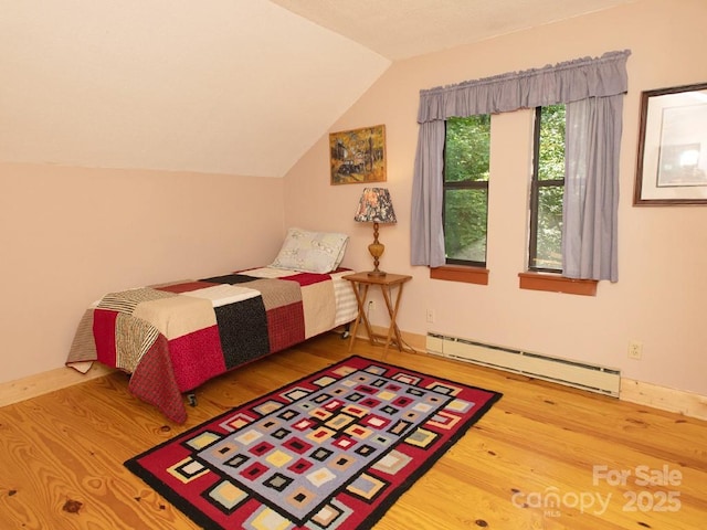 1090 Woolyshot Branch Rd, Hot Springs, NC 28743 - bedroom with a baseboard heating unit, wood finished floors, and lofted ceiling