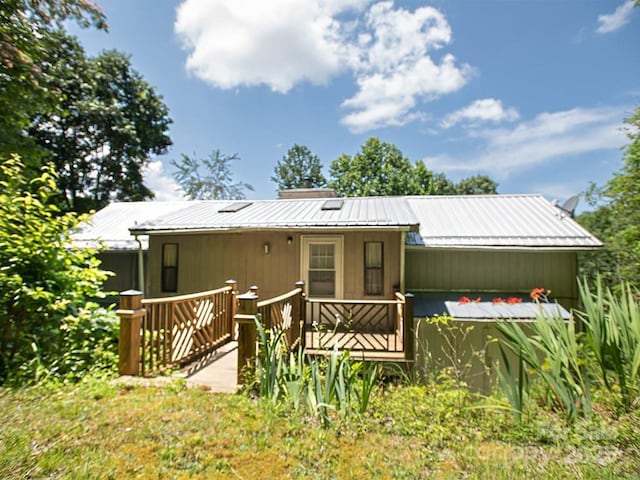 1090 Woolyshot Branch Rd, Hot Springs, NC 28743 - rear view of property with a metal roof, a wooden deck, and a chimney