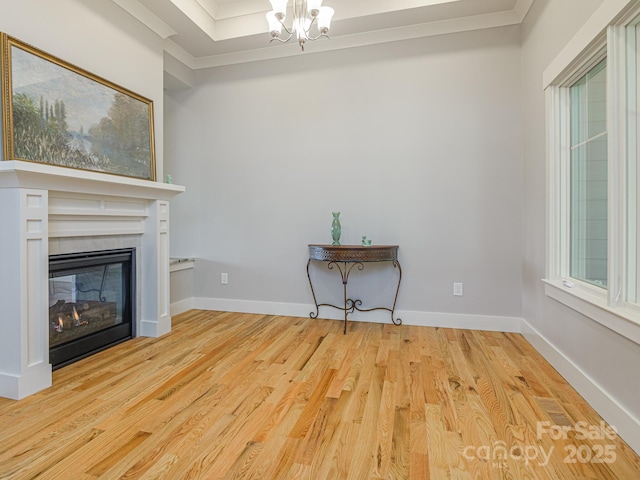 62 Sharp Rd W, Black Mountain, NC 28711 - unfurnished living room with ornamental molding, light wood-type flooring, a chandelier, and a glass covered fireplace