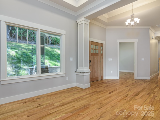 62 Sharp Rd W, Black Mountain, NC 28711 - entrance foyer with ornate columns, ornamental molding, light wood-style flooring, and a chandelier