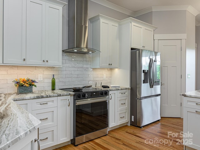 62 Sharp Rd W, Black Mountain, NC 28711 - kitchen with appliances with stainless steel finishes, wall chimney exhaust hood, ornamental molding, backsplash, and light wood-type flooring