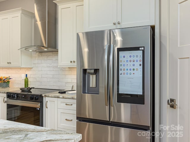 62 Sharp Rd W, Black Mountain, NC 28711 - kitchen featuring stainless steel appliances, wall chimney exhaust hood, light stone counters, and decorative backsplash