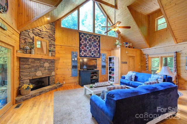 178 Anglers Way, Lake Lure, NC 28746 - living room with high vaulted ceiling, wood walls, a wooden ceiling with exposed beams, a stone fireplace, and wood finished floors
