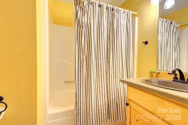 178 Anglers Way, Lake Lure, NC 28746 - bathroom with a textured wall, vanity, and shower / bath combo with shower curtain