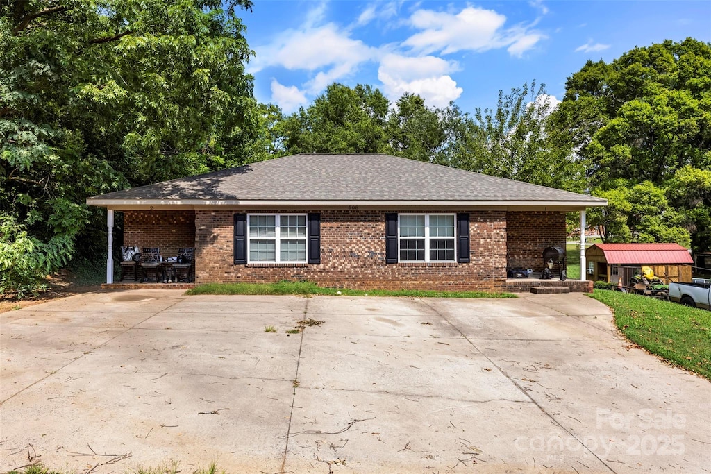 508 Gantt St Unit 1-2, Kings Mountain, NC 28086 - view of front of house featuring brick siding, roof with shingles, and view of wooded area