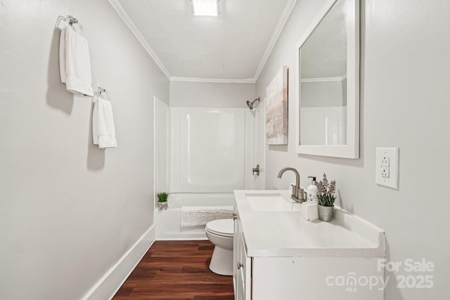 911 Elm St, Kannapolis, NC 28081 - bathroom featuring ornamental molding, vanity, tub / shower combination, and wood finished floors