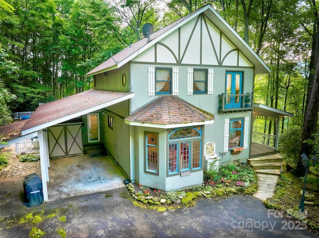 1504 Red Marble Rd, Andrews, NC 28901 - view of front of property featuring a shingled roof, driveway, stucco siding, a carport, and covered porch