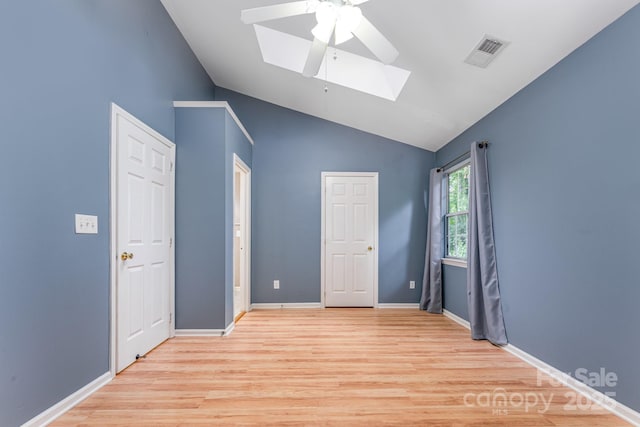1250 Maple Shade Ln, Charlotte, NC 28270 - unfurnished bedroom featuring a skylight, lofted ceiling, light wood-style flooring, and a ceiling fan