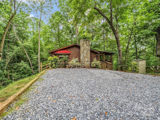 116 Chalet Rd, Lake Lure, NC 28746 - view of home's exterior featuring driveway and a chimney