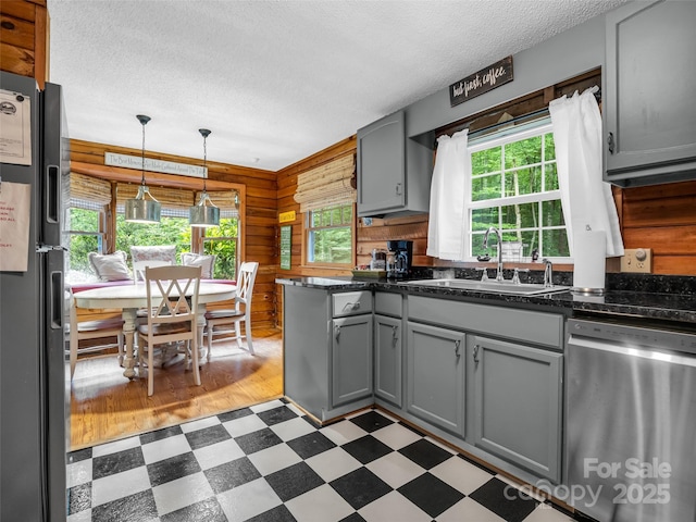 116 Chalet Rd, Lake Lure, NC 28746 - kitchen with stainless steel dishwasher, fridge with ice dispenser, gray cabinets, light flooring, and a textured ceiling