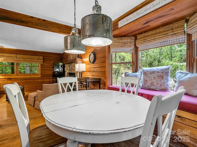 116 Chalet Rd, Lake Lure, NC 28746 - dining room featuring wood walls, wood finished floors, and beam ceiling