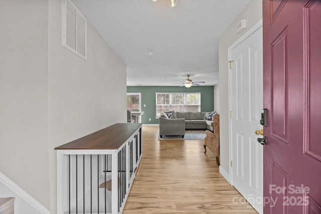 8009 Trotter Rd, Charlotte, NC 28216 - foyer entrance with light wood-style flooring, ceiling fan, and a textured ceiling