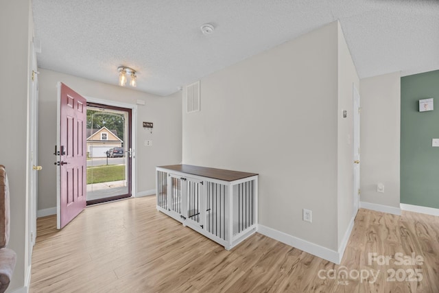 8009 Trotter Rd, Charlotte, NC 28216 - entrance foyer featuring light wood-type flooring and a textured ceiling