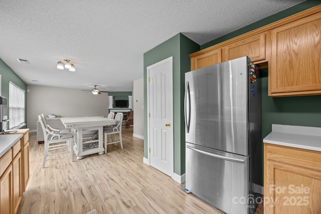 8009 Trotter Rd, Charlotte, NC 28216 - kitchen featuring freestanding refrigerator, a ceiling fan, light wood finished floors, a textured ceiling, and light countertops