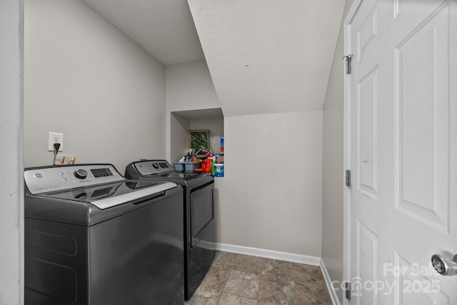 8009 Trotter Rd, Charlotte, NC 28216 - laundry area featuring independent washer and dryer, a textured ceiling, and stone finish flooring