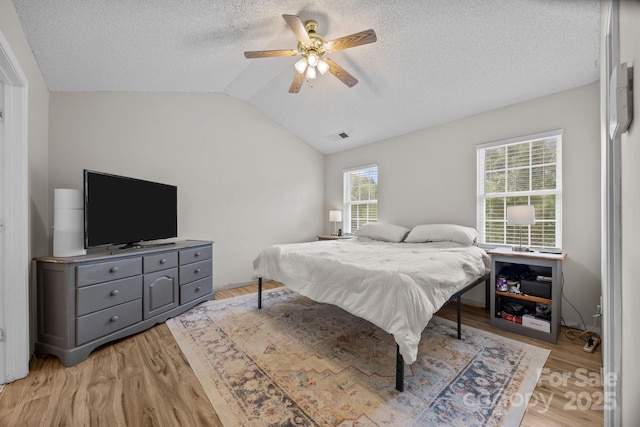 8009 Trotter Rd, Charlotte, NC 28216 - bedroom featuring vaulted ceiling, light wood-style floors, a textured ceiling, and ceiling fan