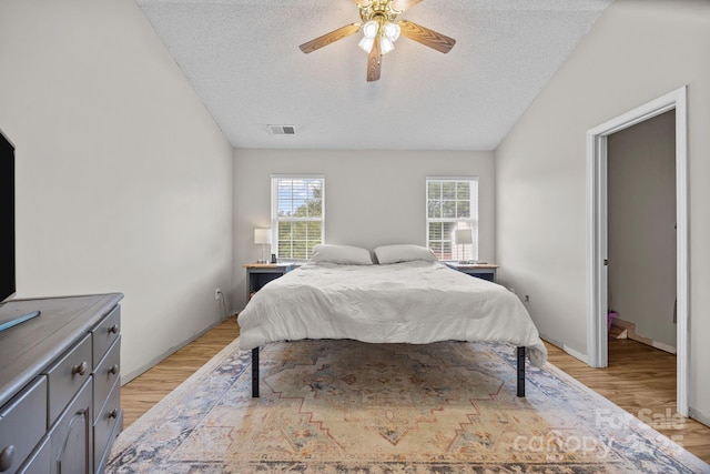 8009 Trotter Rd, Charlotte, NC 28216 - bedroom with a textured ceiling, light wood finished floors, ceiling fan, and vaulted ceiling
