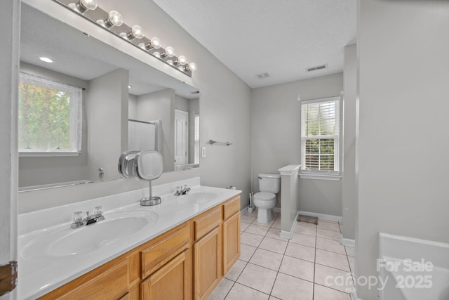 8009 Trotter Rd, Charlotte, NC 28216 - bathroom featuring double vanity, tile patterned flooring, a shower, and a textured ceiling